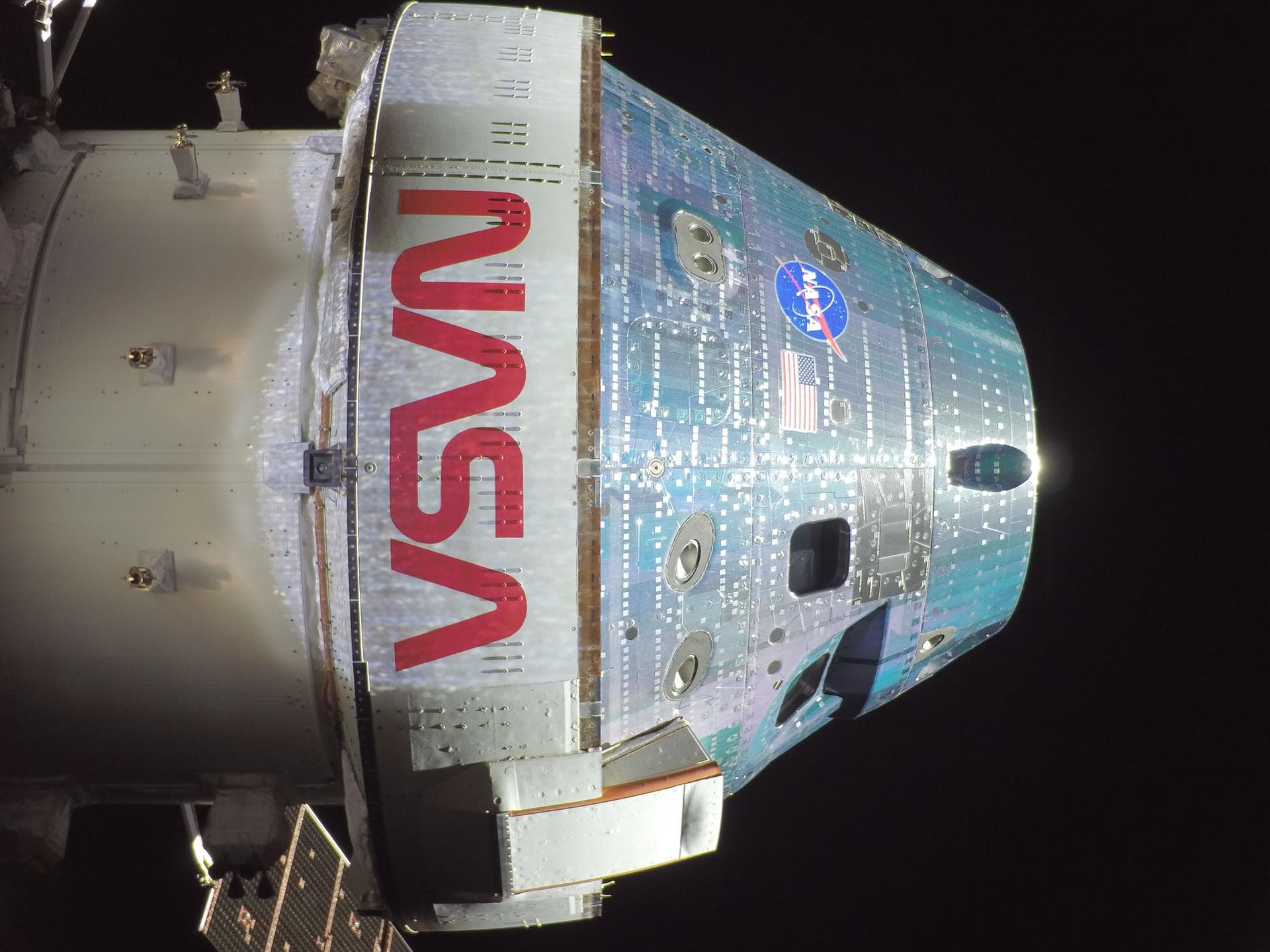 The Orion spacecraft during the Artemis II mission, showing the NASA logo and crew module