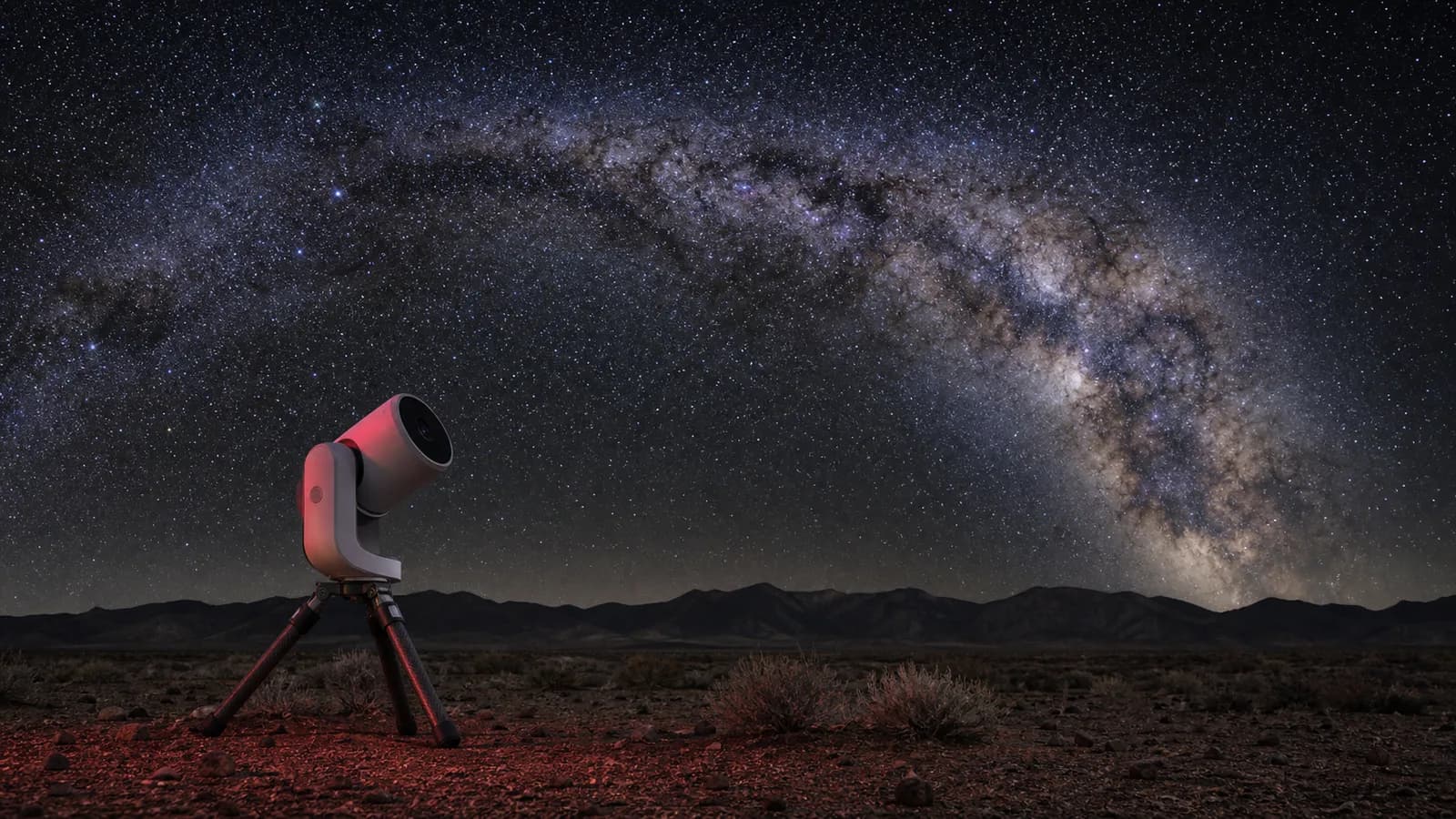 Compact smart telescope on a portable tripod at a dark-sky site with the Milky Way overhead